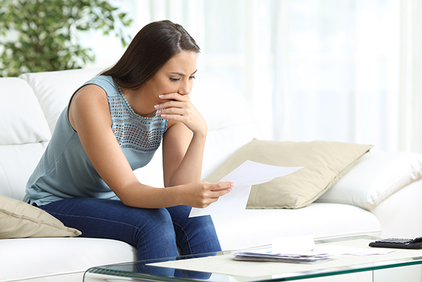 Serious confused young couple checking bills, bank, loan documents with using laptop, large credit card bills, reading bad news, having debt financial problem concept