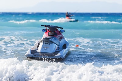 jetski sitting in the waves on a beach at a shore ex place