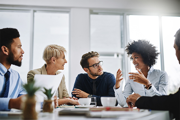 Shot of a team of colleagues celebrating with a high five in a modern office