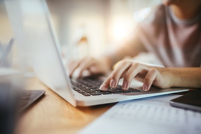 Yacht crew member on a laptop looking up help for yacht crew insurance issues