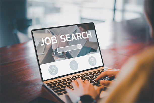 African man browsing work opportunities online using job search computer app, black jobless seeker looking for new vacancies on website page at laptop screen, recruitment concept, rear close up view